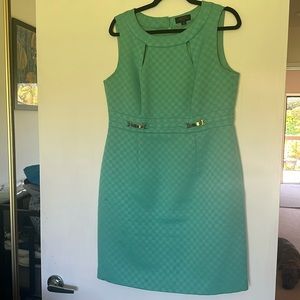 Tahari sleeveless, boat neck, jewel, green dress with silver front details.